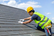 Roofing contractor with roof shingles