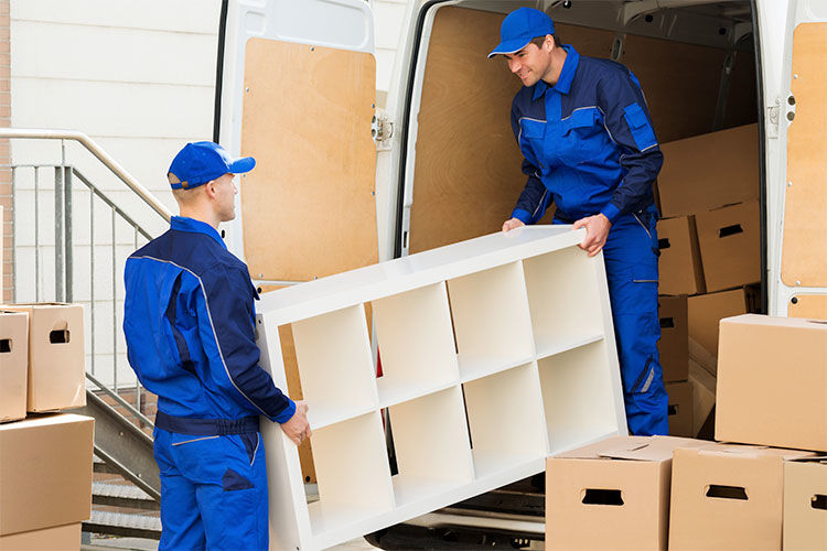 Men moving furniture out of a delivery van
