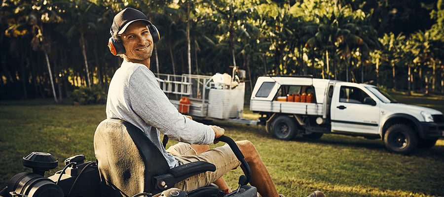 Landscaper Riding a Lawn Mower