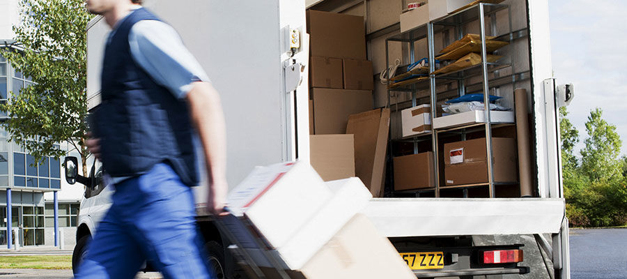 Delivery driver unloading a box truck