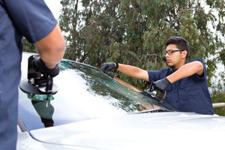 Mobile auto glass technicians installing a windshield