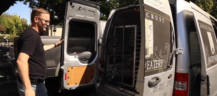 Bakery owner in front of delivery van